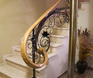 wrought iron railing with wooden handrails
